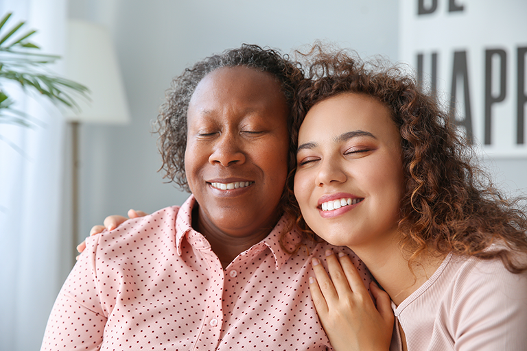 Staff member hugging a client